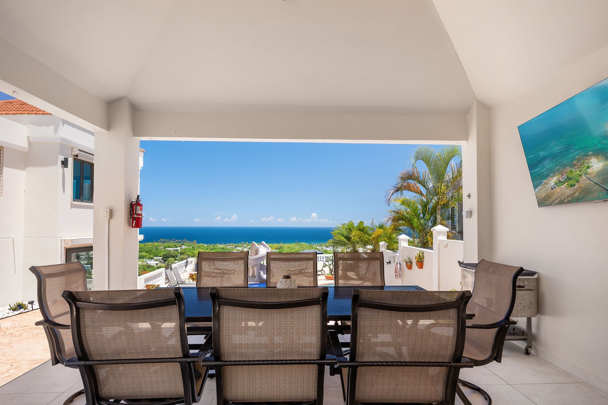 Covered terrace dining with ocean horizon