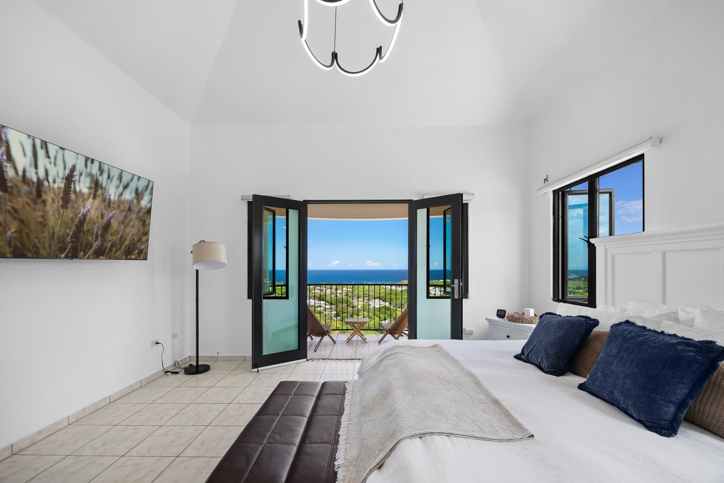 Bedroom with doors opening to the ocean view