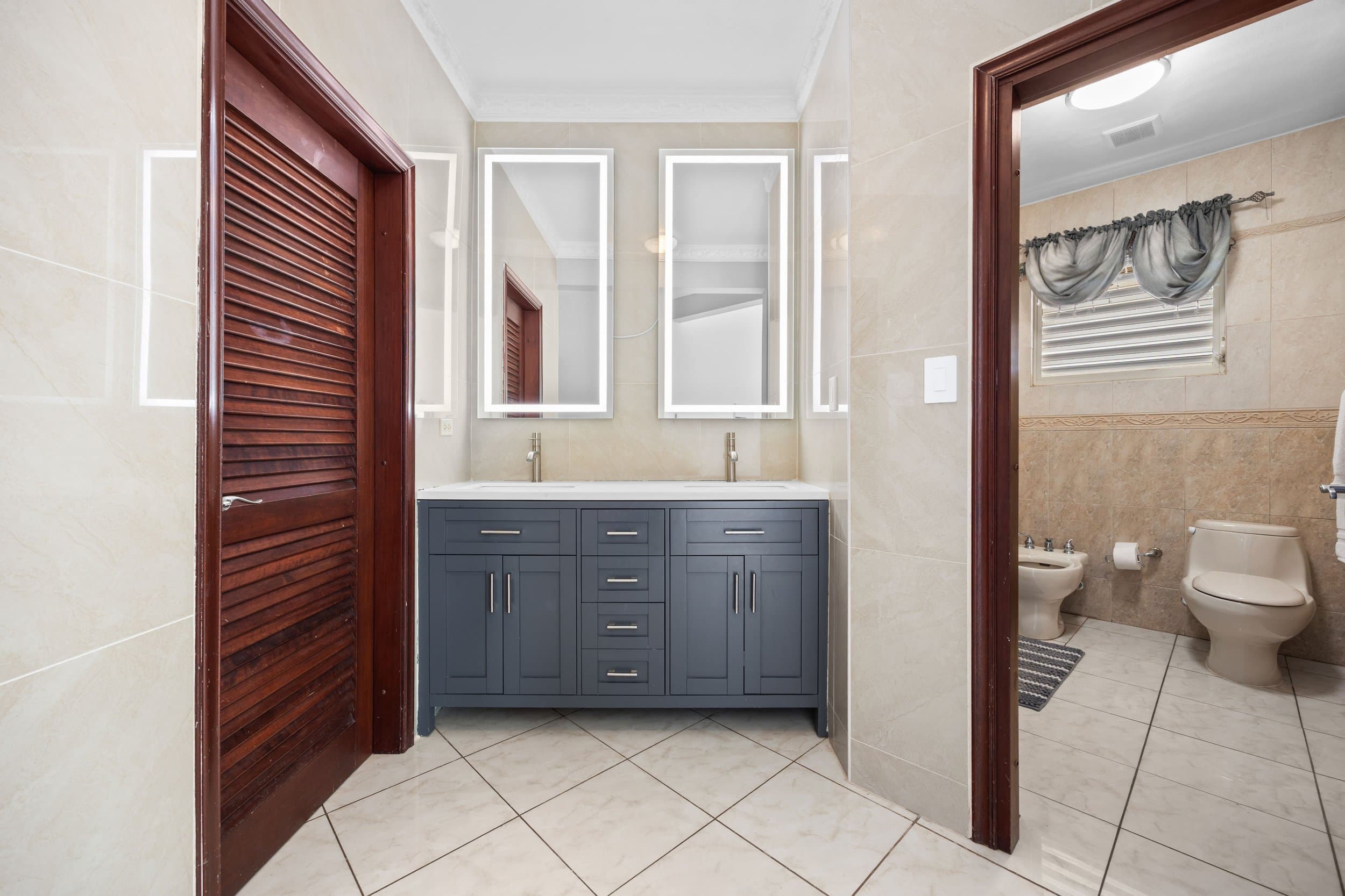 Marble bath with mahogany doors