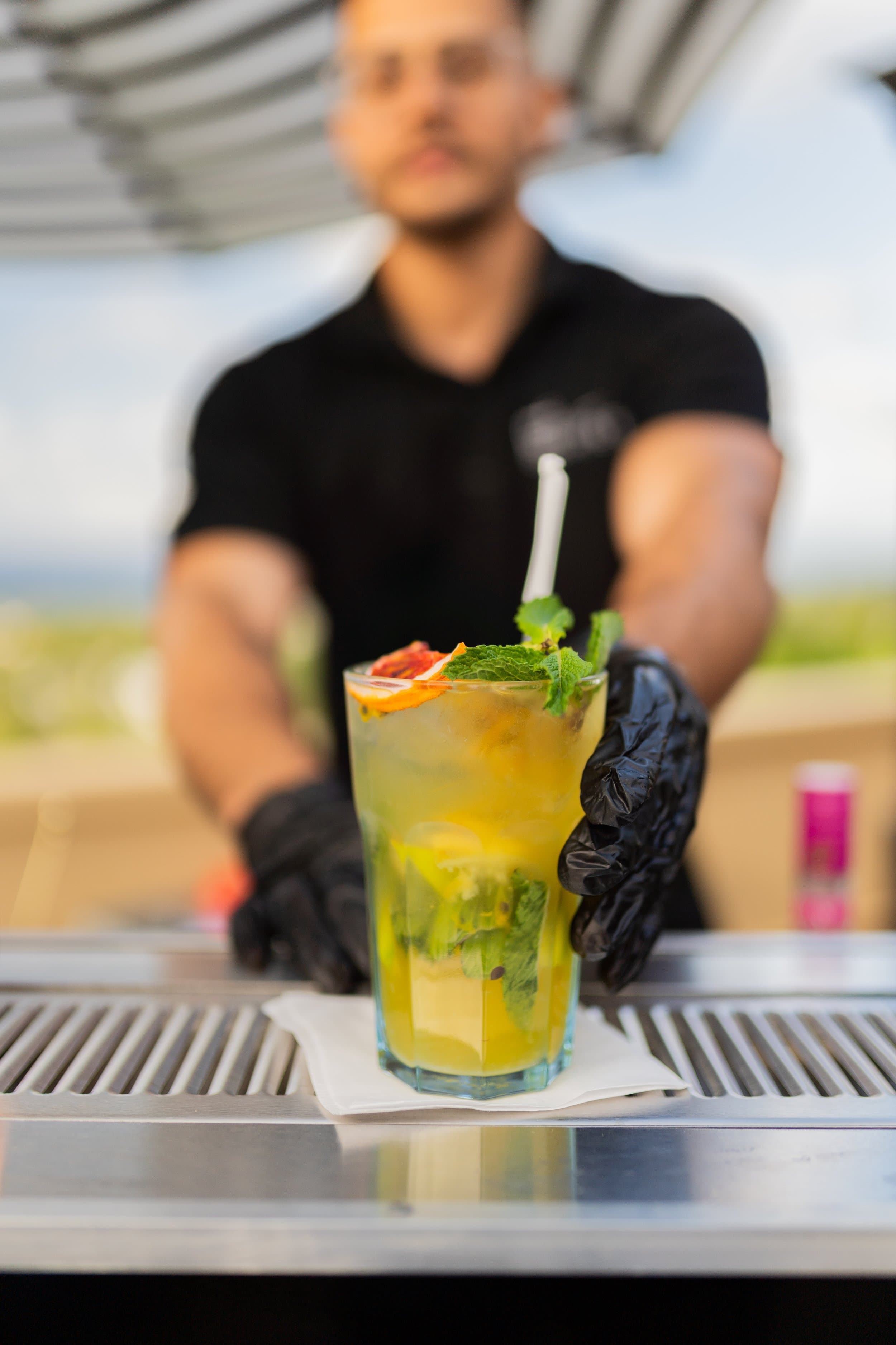 Bartender serving mojitos at the villa bar