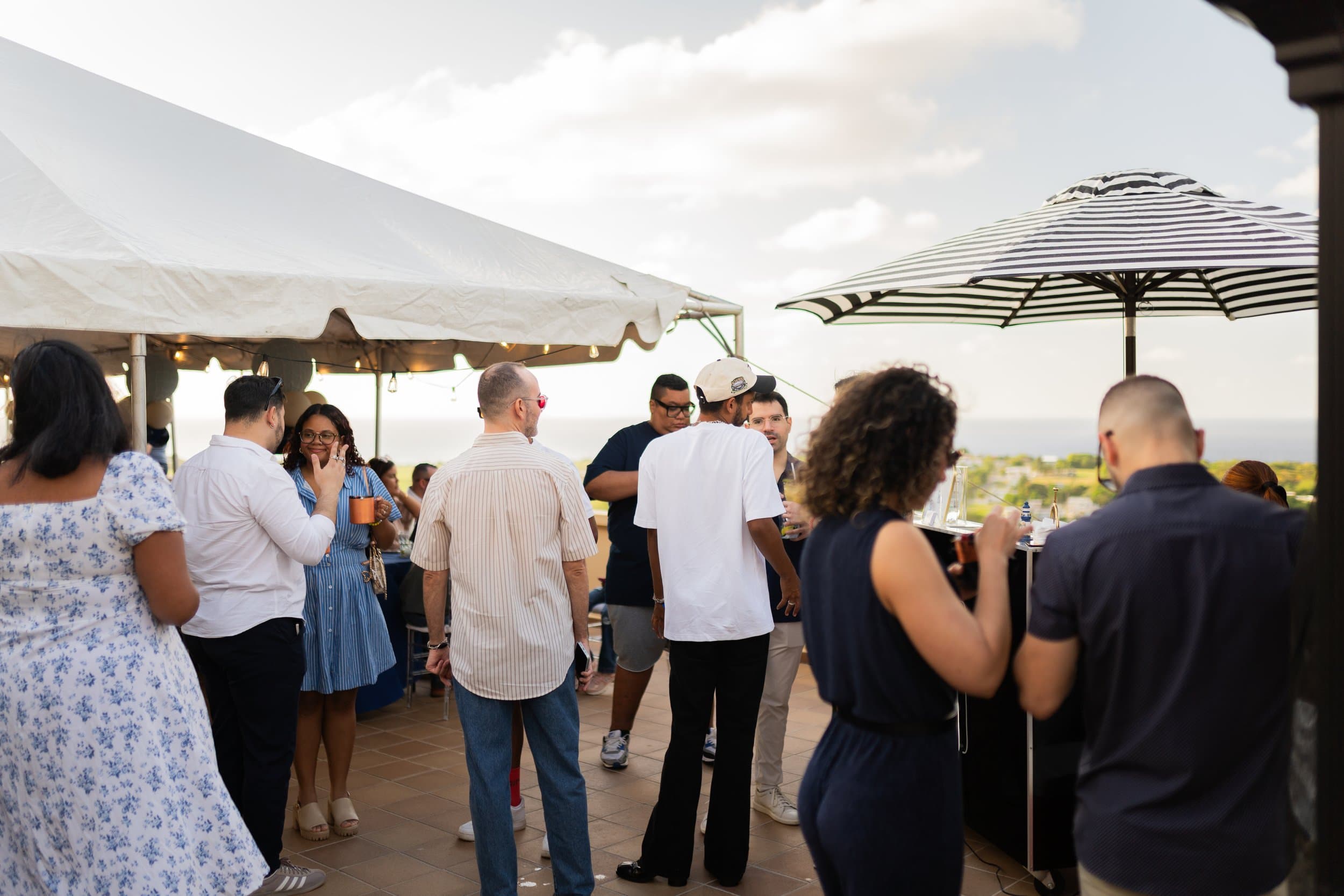 Baby shower guests mingling by the terrace bar