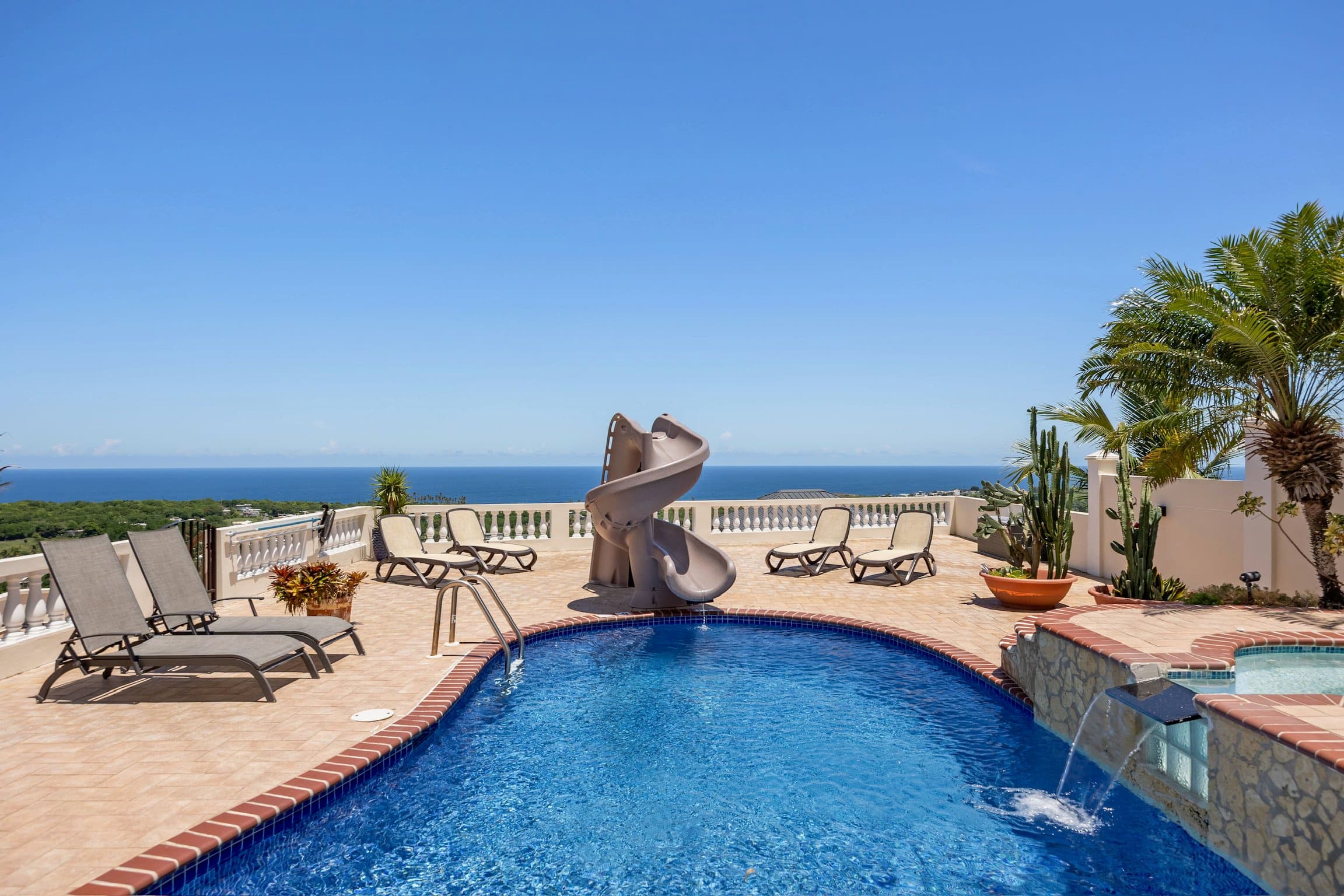 Pool deck and slide under a blue sky