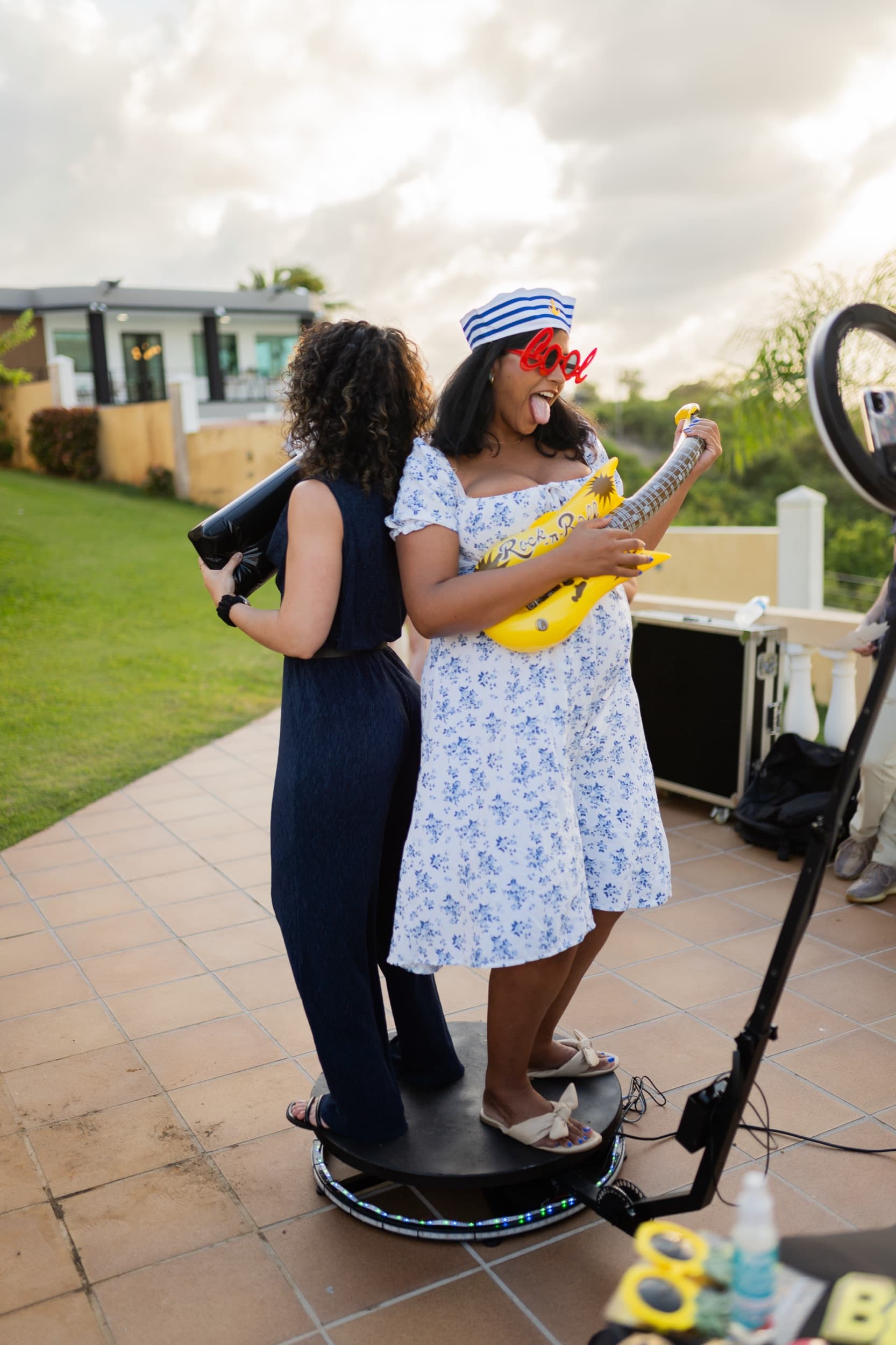 Guests on the 360 photo booth at a baby shower