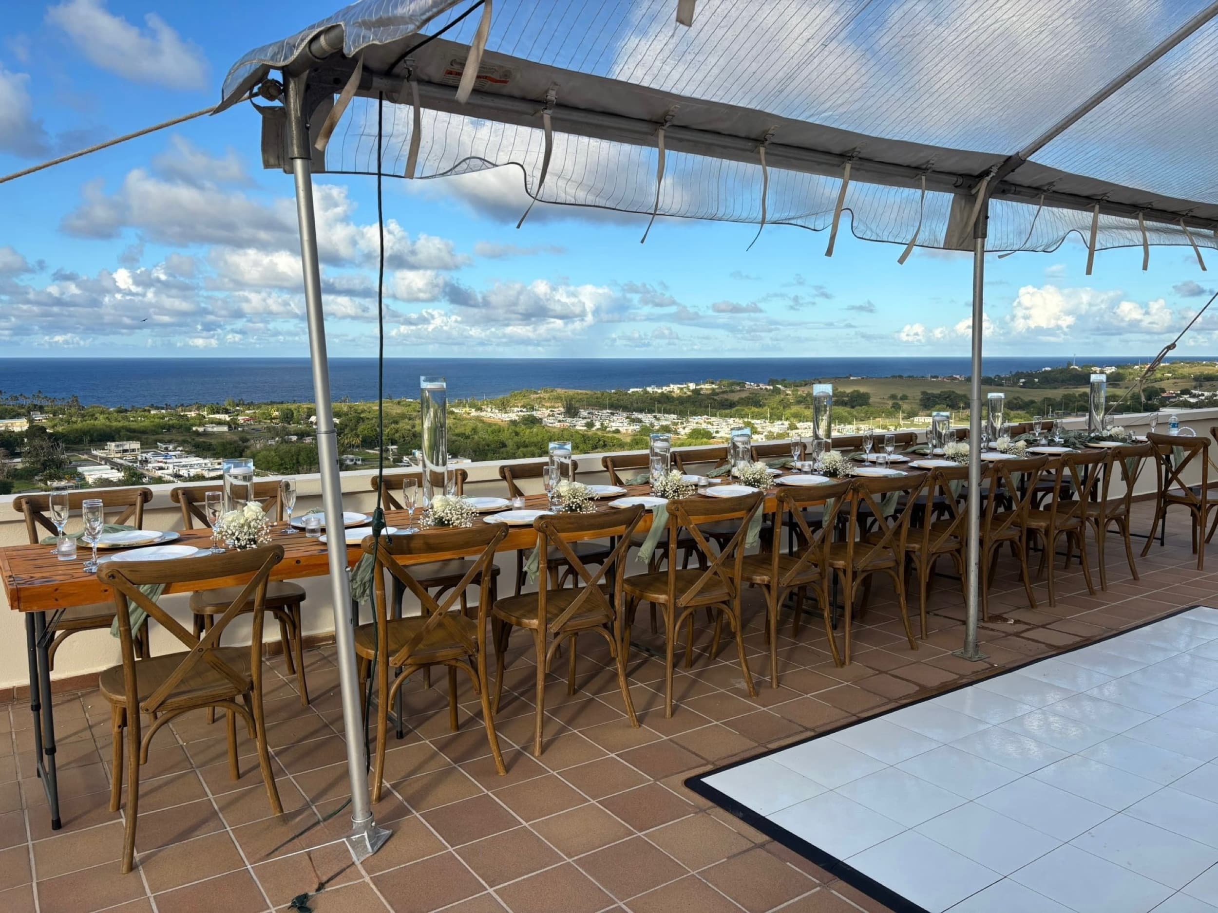 Dinner table set under the clear-top tent with ocean views