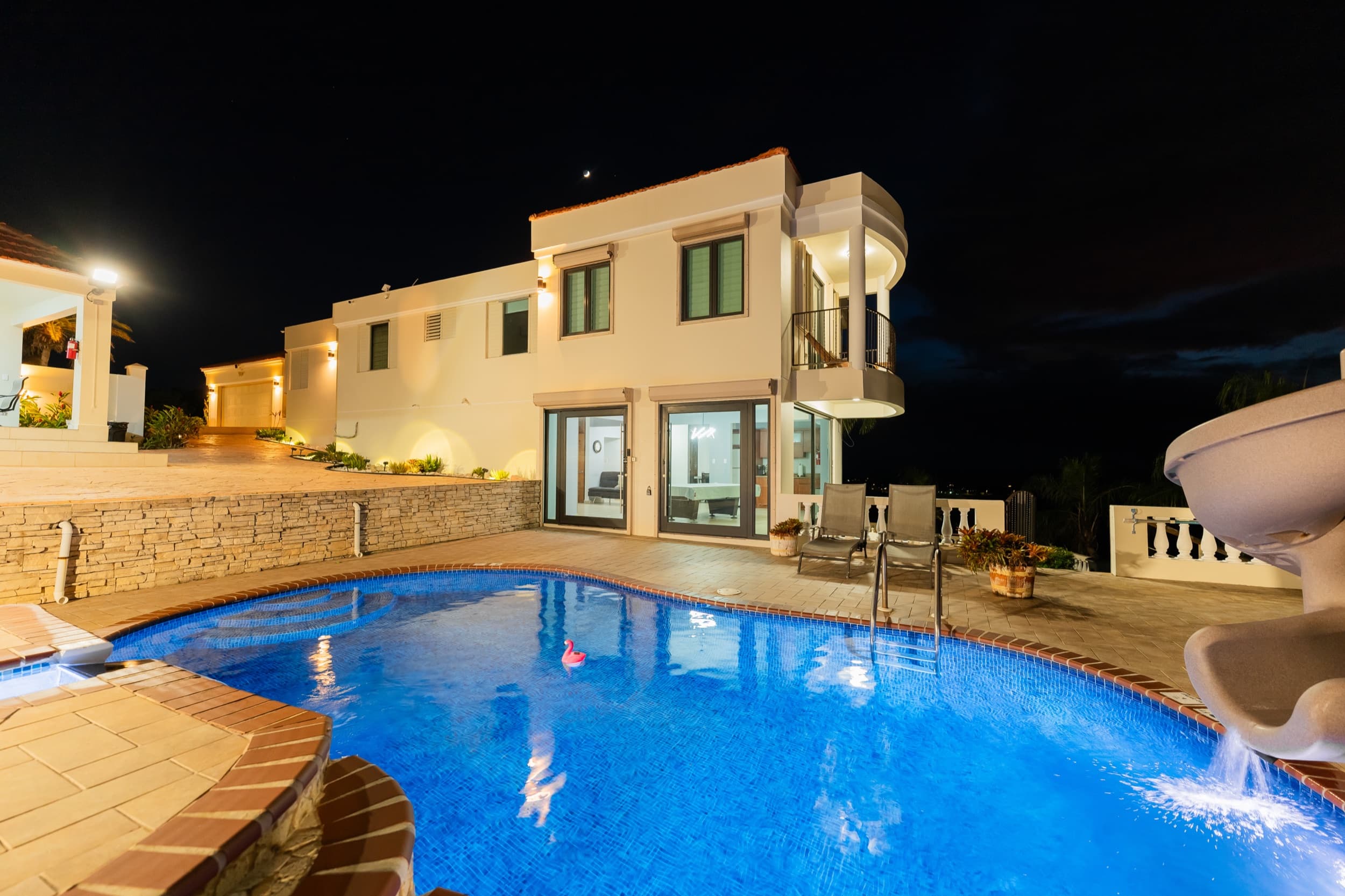 The pool glowing electric blue after dark