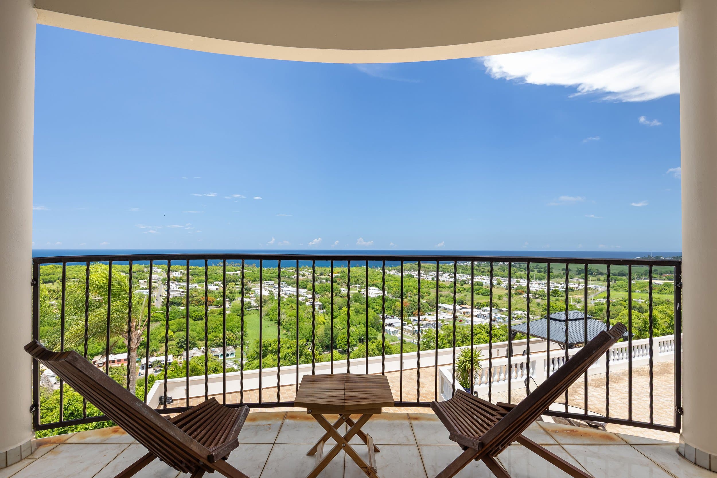 Balcony bistro chairs facing the coast