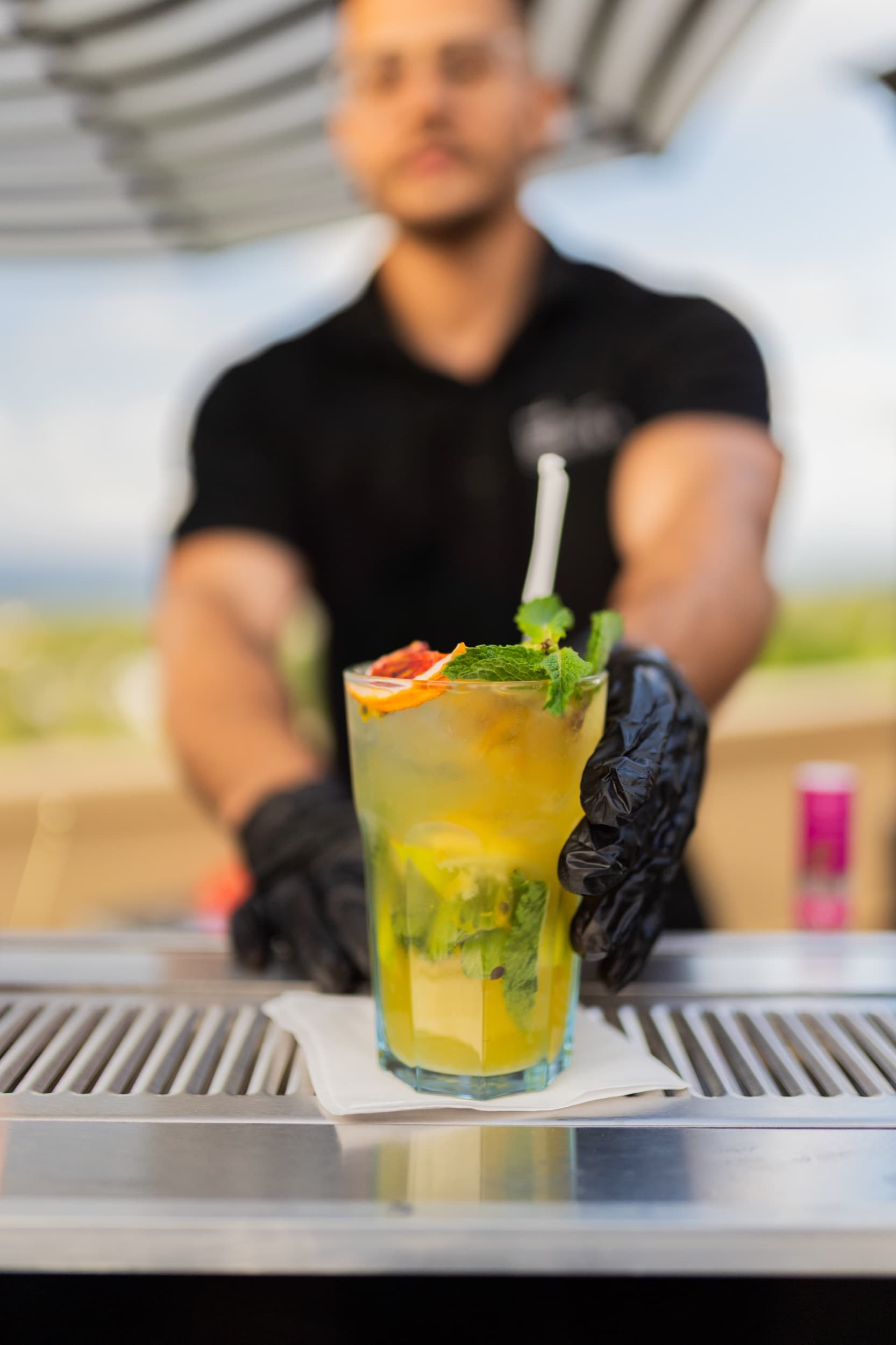 Bartender serving mojitos at the villa bar